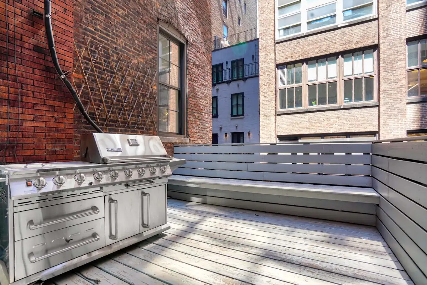 Private outdoor terrace framed by historic brick