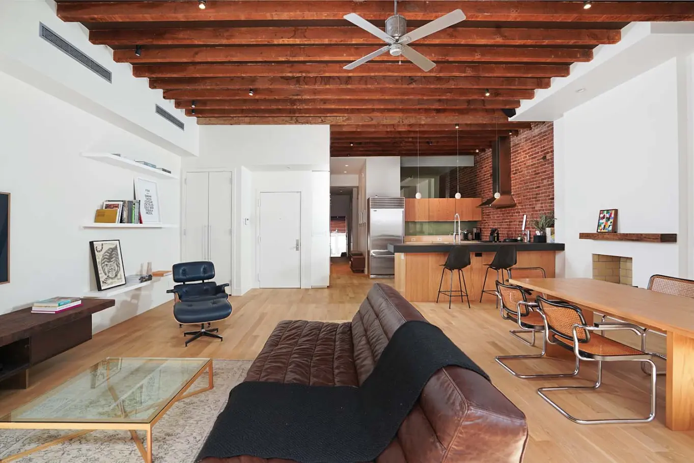 Open loft residence with twelve-foot timber ceiling, exposed brick, and south-facing windows