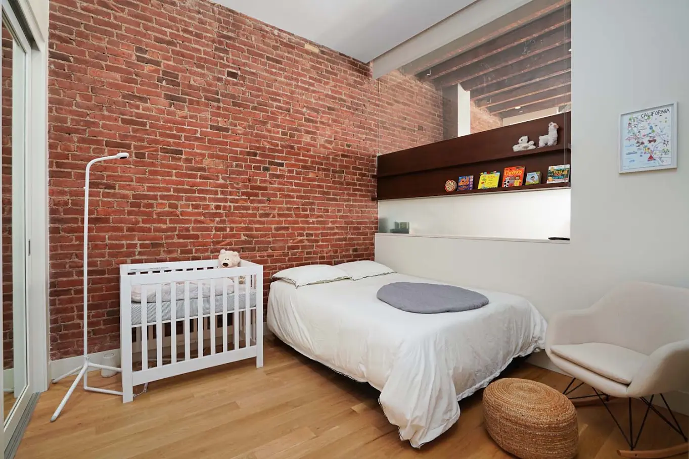 Bedroom framed by exposed brick